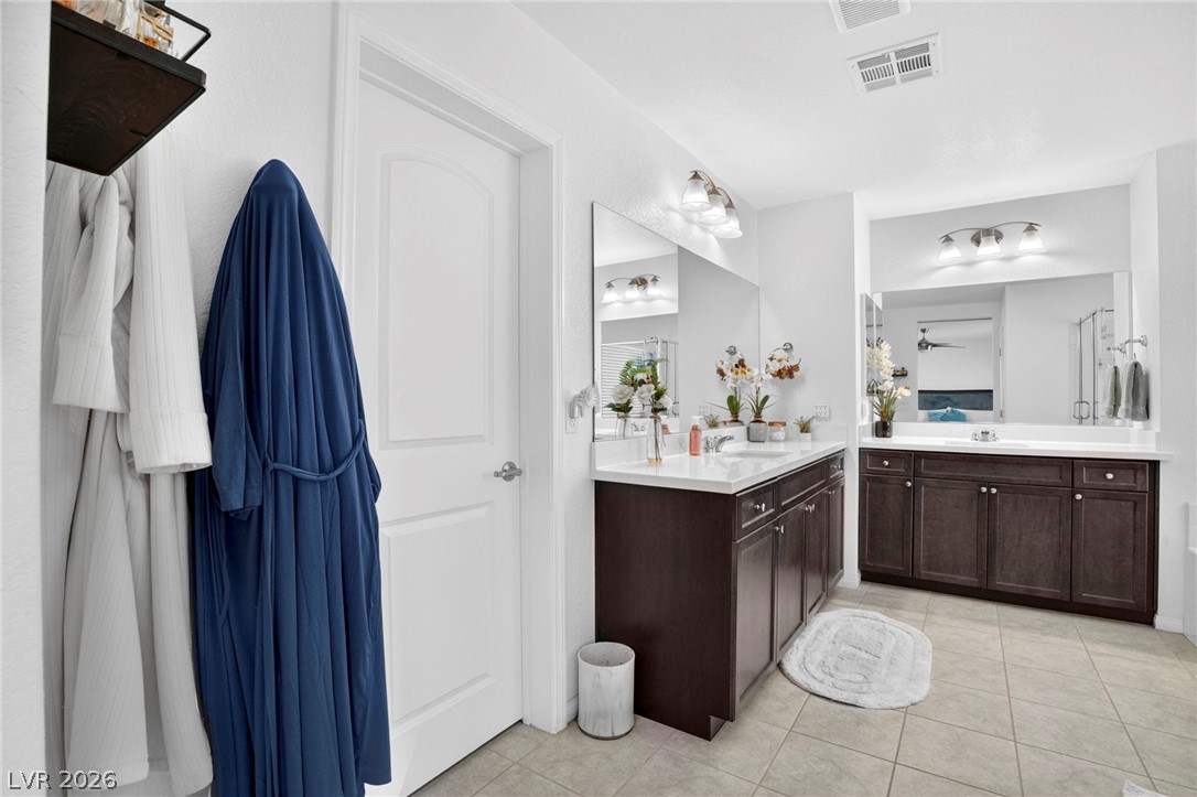 6281 Angora Peak Lane Las Vegas, NV 89115 - Photo 18 of 34 Dual vanities with ample storage enhance this well-appointed bath.