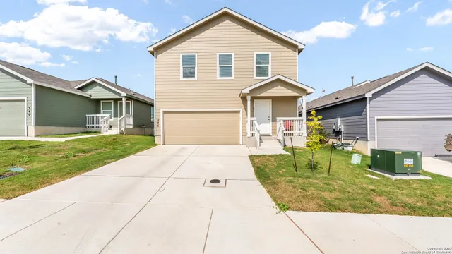 a front view of house with yard and green space