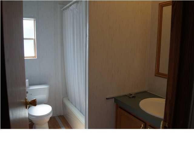 39 East Burnis Road Crestview, FL 32539 - Photo 9 of 12 a bathroom with a toilet a sink and mirror