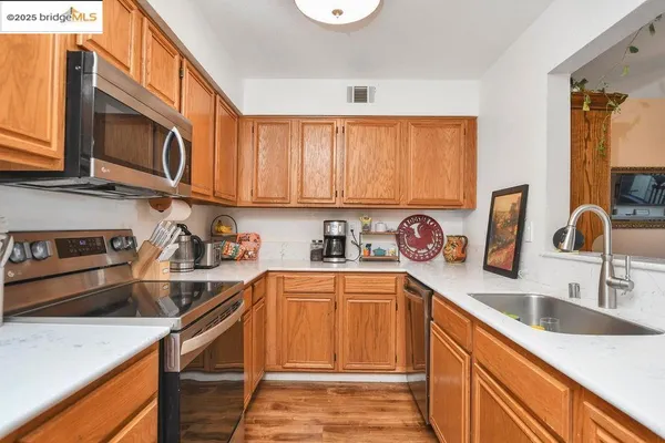 a kitchen with a refrigerator stove and microwave