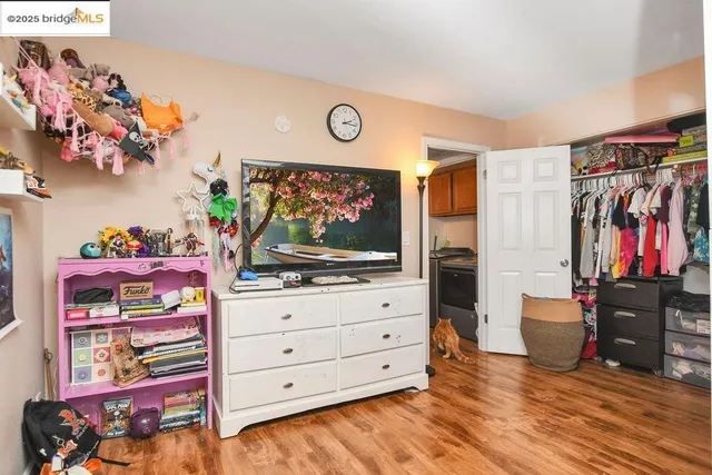 a bedroom with a bed and a view of kitchen