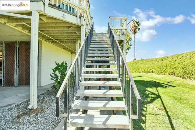 a living room with furniture a rug and a chandelier