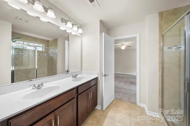 an empty room with windows and ceiling fan