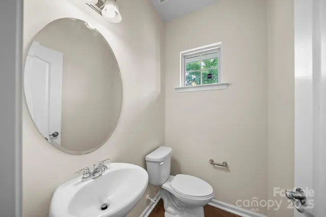 a bathroom with a sink mirror and toilet