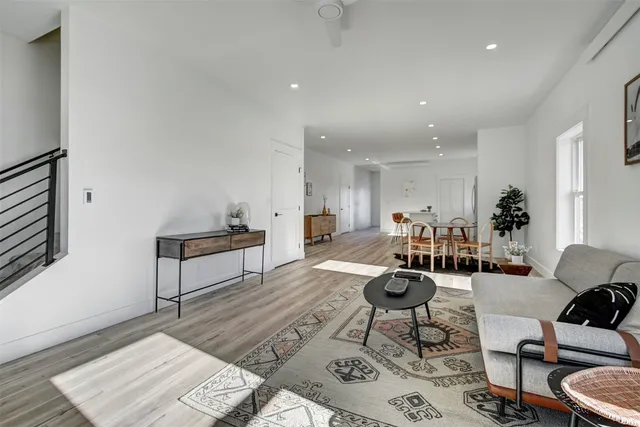 a living room with furniture a rug and a table