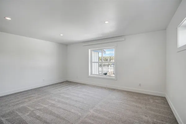 an empty room with wooden floor windows and view of wooden floor