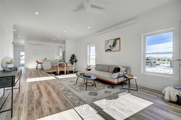 a living room with furniture and wooden floor