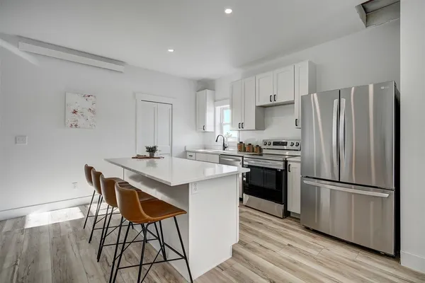 a kitchen with a sink stove and cabinets