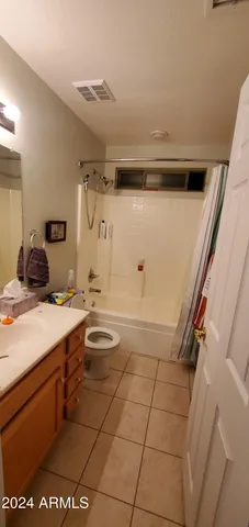 a bathroom with a granite countertop sink a toilet and shower