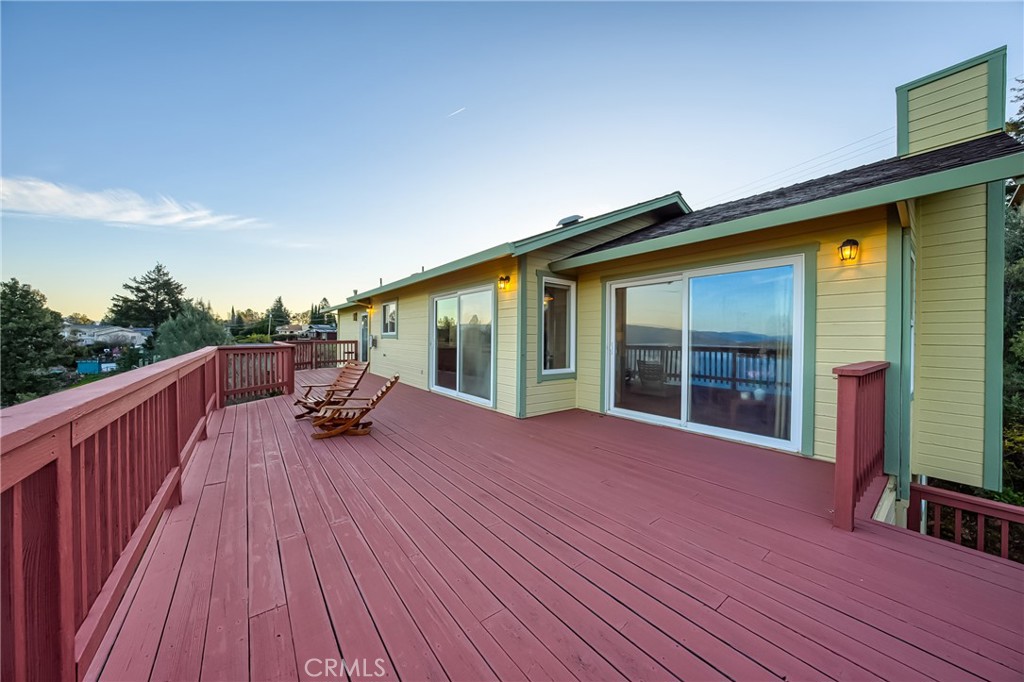 4777 Hawaina Way Kelseyville, CA 95451 - Photo 15 of 48 a view of a house with wooden deck and furniture