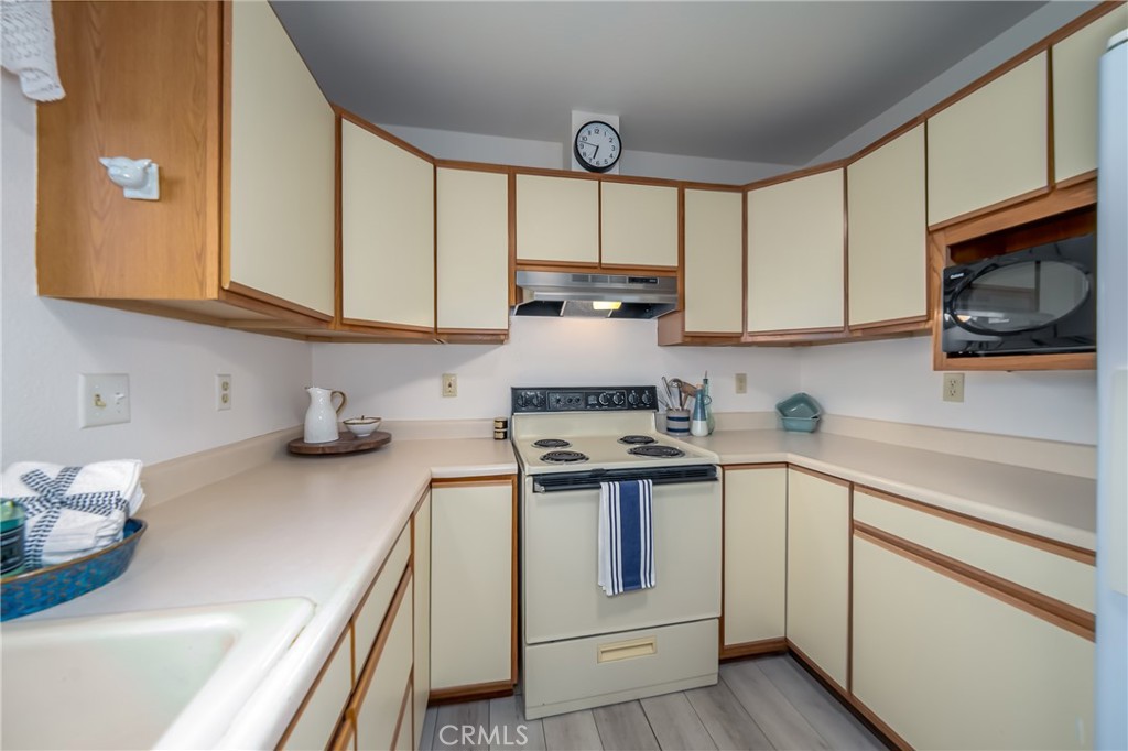 4777 Hawaina Way Kelseyville, CA 95451 - Photo 18 of 48 a kitchen with stainless steel appliances granite countertop a sink stove and cabinets