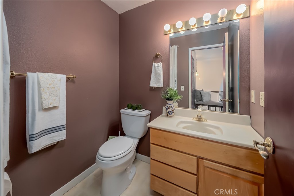 4777 Hawaina Way Kelseyville, CA 95451 - Photo 23 of 48 a bathroom with a toilet sink and mirror