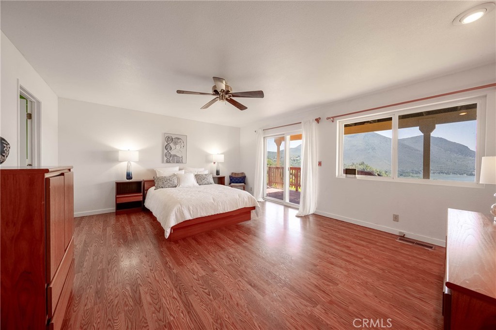 4777 Hawaina Way Kelseyville, CA 95451 - Photo 27 of 48 a spacious bedroom with a large bed and a chandelier