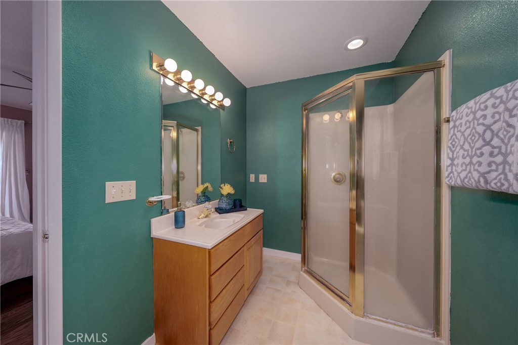 4777 Hawaina Way Kelseyville, CA 95451 - Photo 34 of 48 a bathroom with a sink mirror and a shower