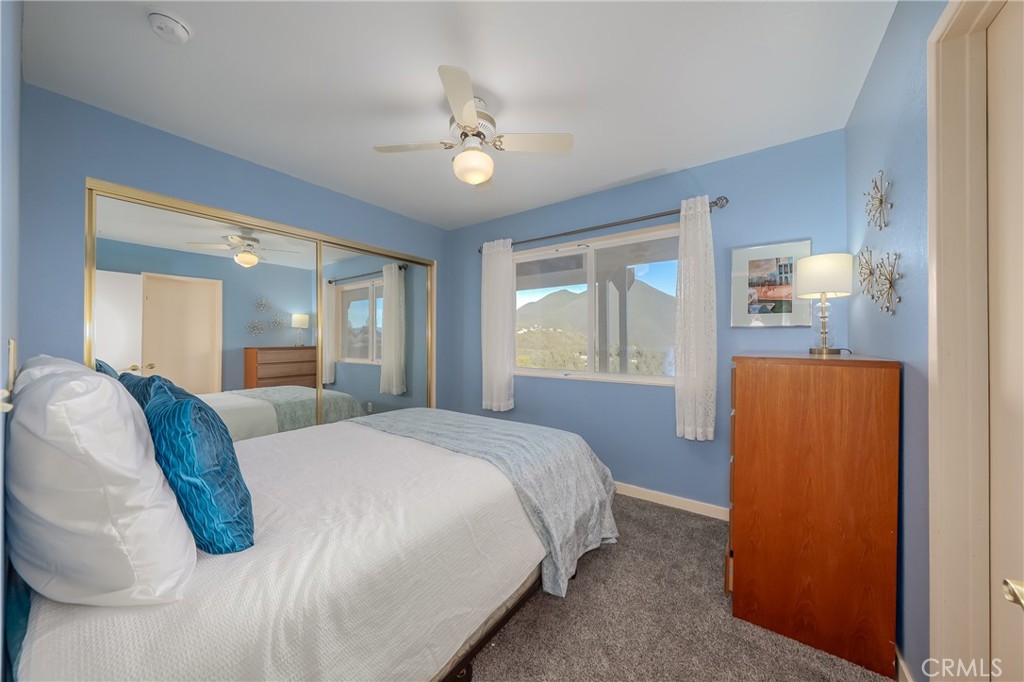 4777 Hawaina Way Kelseyville, CA 95451 - Photo 36 of 48 a bedroom with a bed and a chandelier