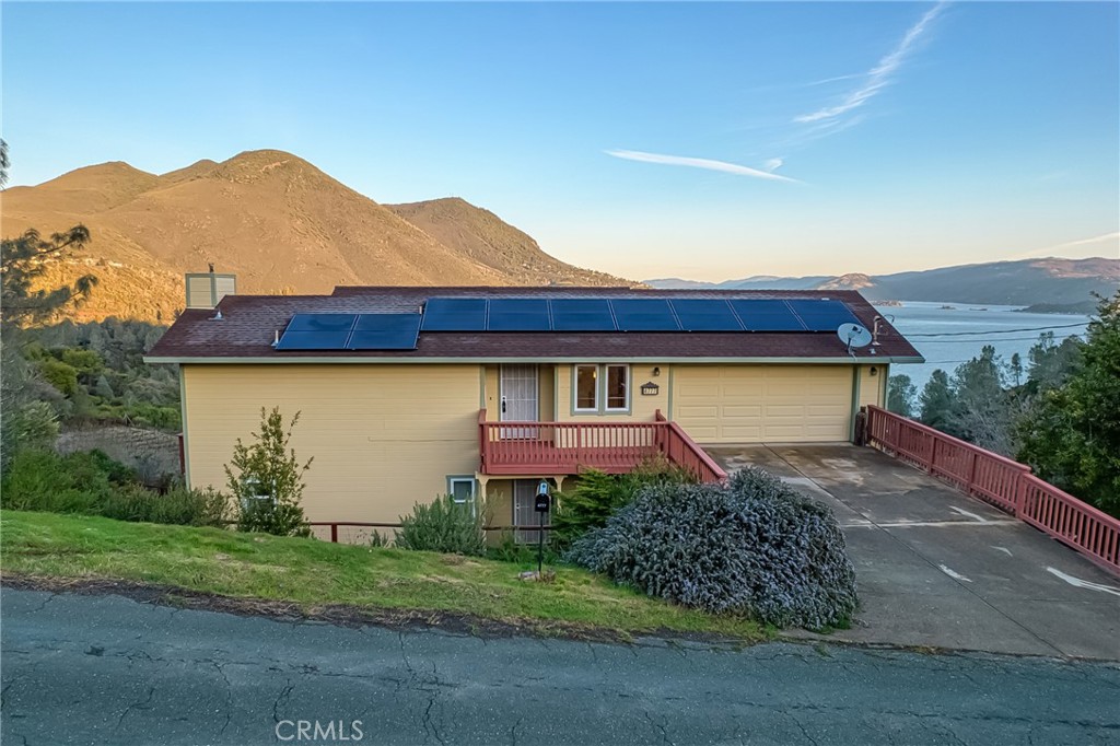 4777 Hawaina Way Kelseyville, CA 95451 - Photo 45 of 48 a front view of a house with a yard and garage