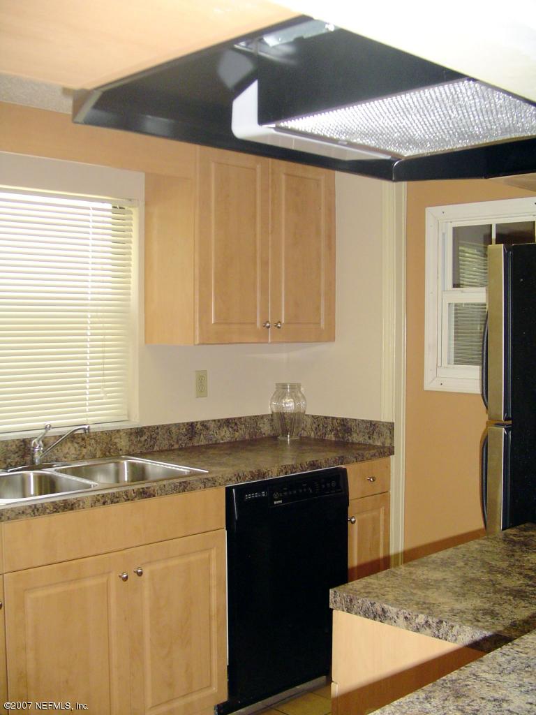12766 Attrill Road Jacksonville, FL 32258 - Photo 3 of 12 a kitchen with stainless steel appliances granite countertop a sink stove and cabinets