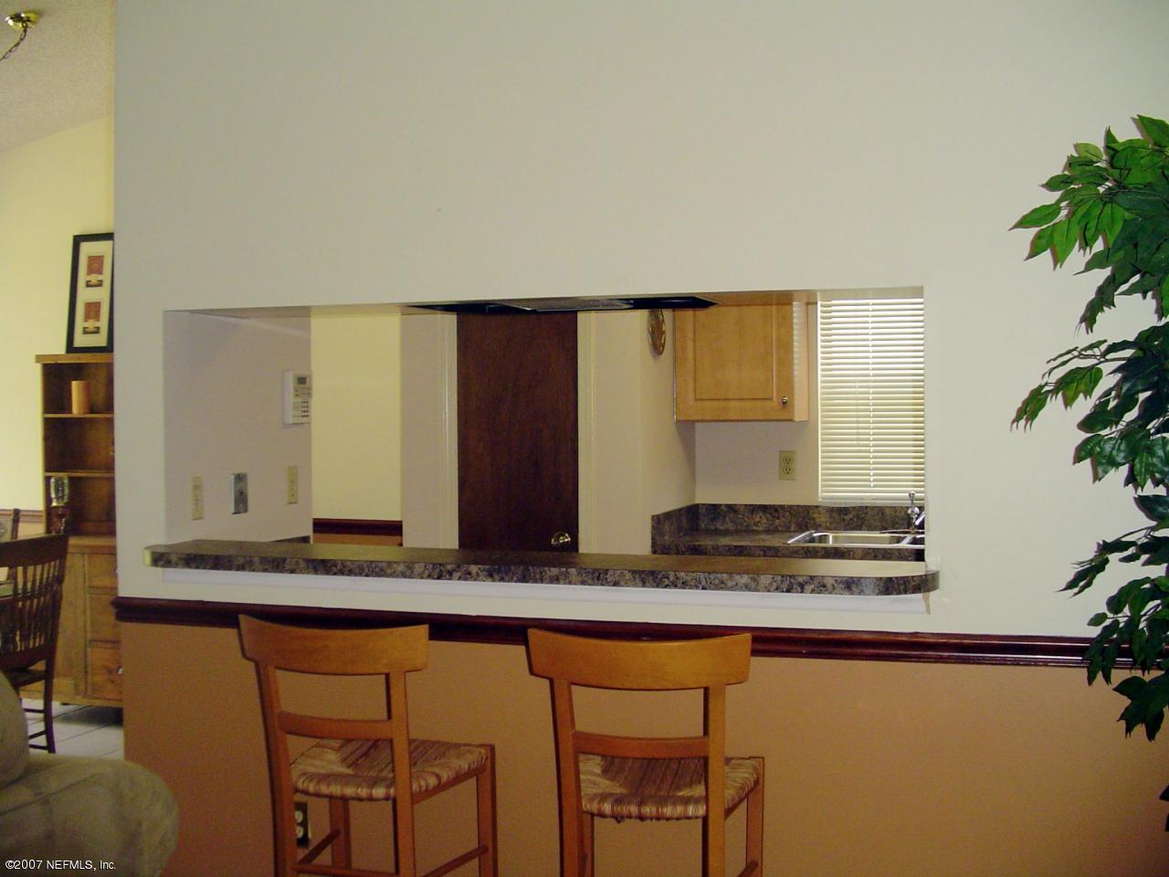 12766 Attrill Road Jacksonville, FL 32258 - Photo 4 of 12 a kitchen with stainless steel appliances granite countertop a sink and a stove