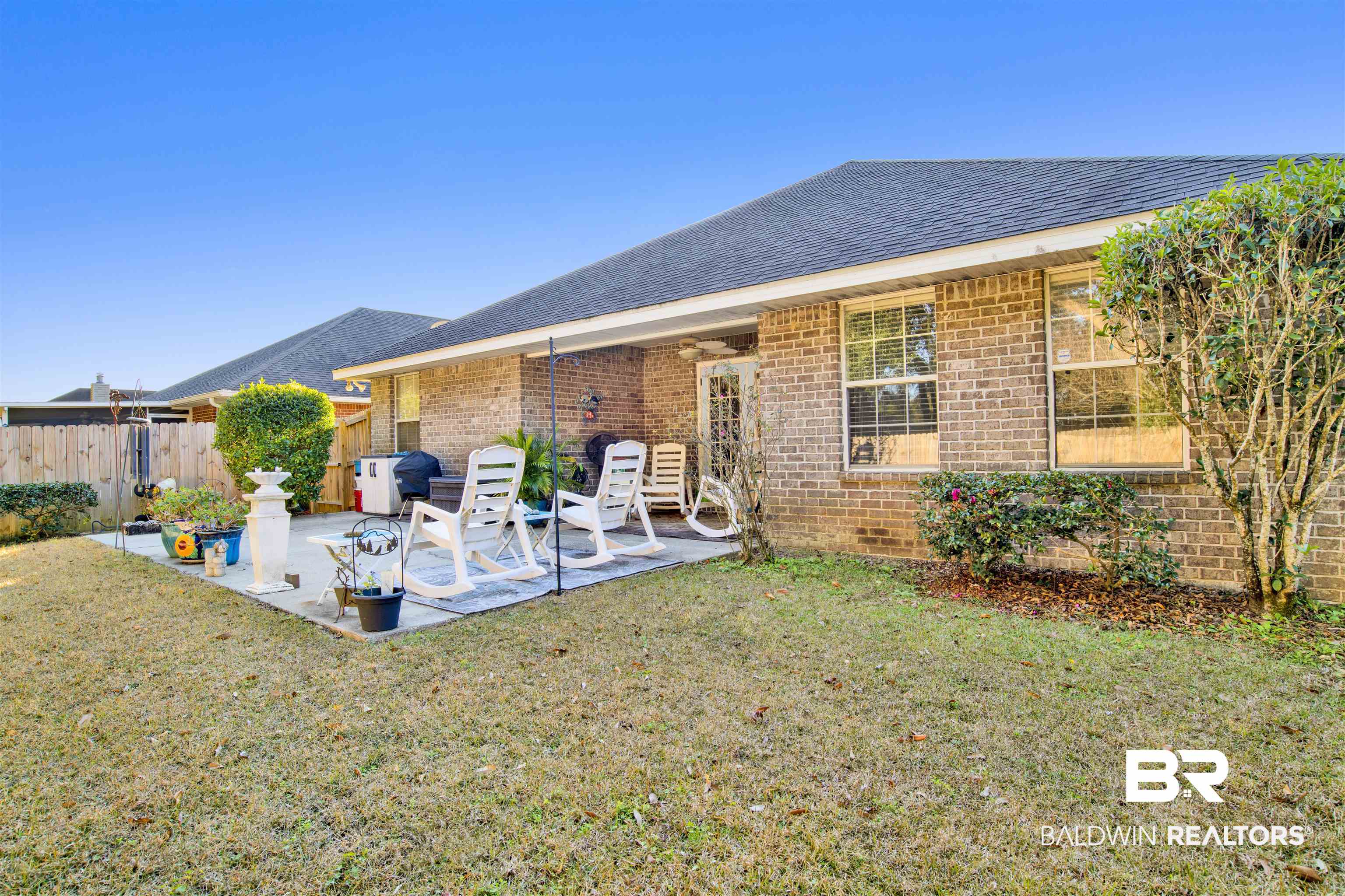 314 Blackfriars Street Fairhope, AL 36532 - Photo 23 of 25 Back of property featuring a lawn and a patio area