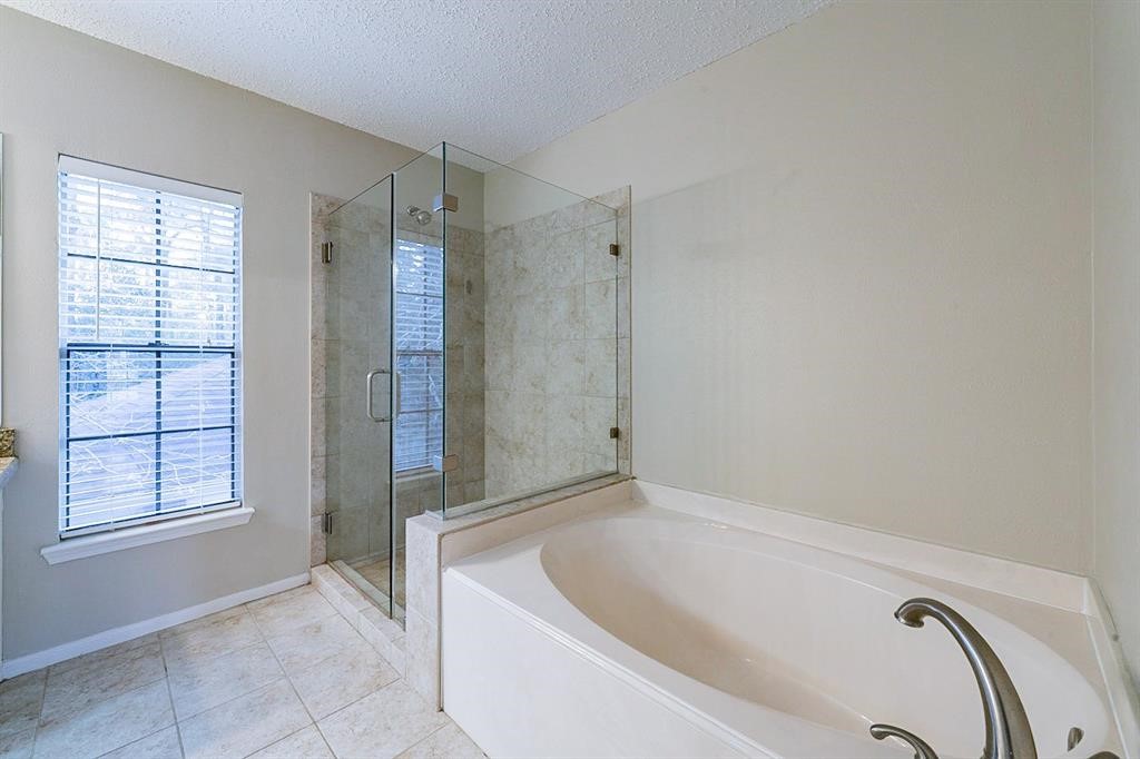 75 Breezy Point Place The Woodlands, TX 77381 - Photo 14 of 19 Primary bath with frameless shower enclosure.