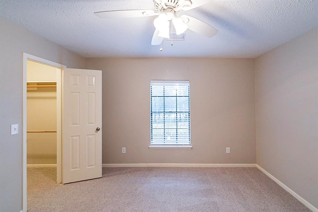 75 Breezy Point Place The Woodlands, TX 77381 - Photo 17 of 19 Another secondary bedroom.