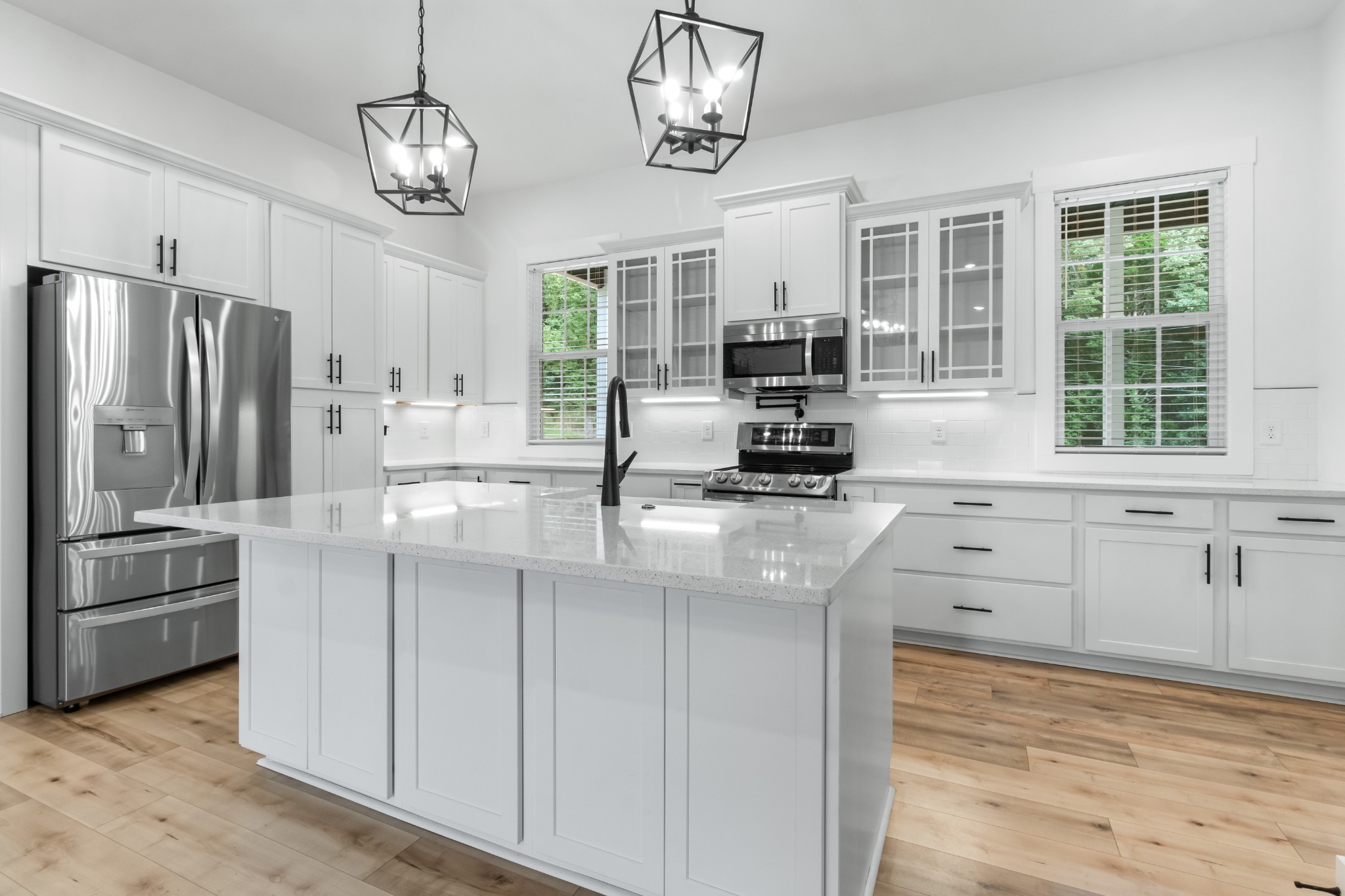 4700 Akin Road Cunningham, TN 37052 - Photo 13 of 36 a kitchen with kitchen island white cabinets and stainless steel appliances