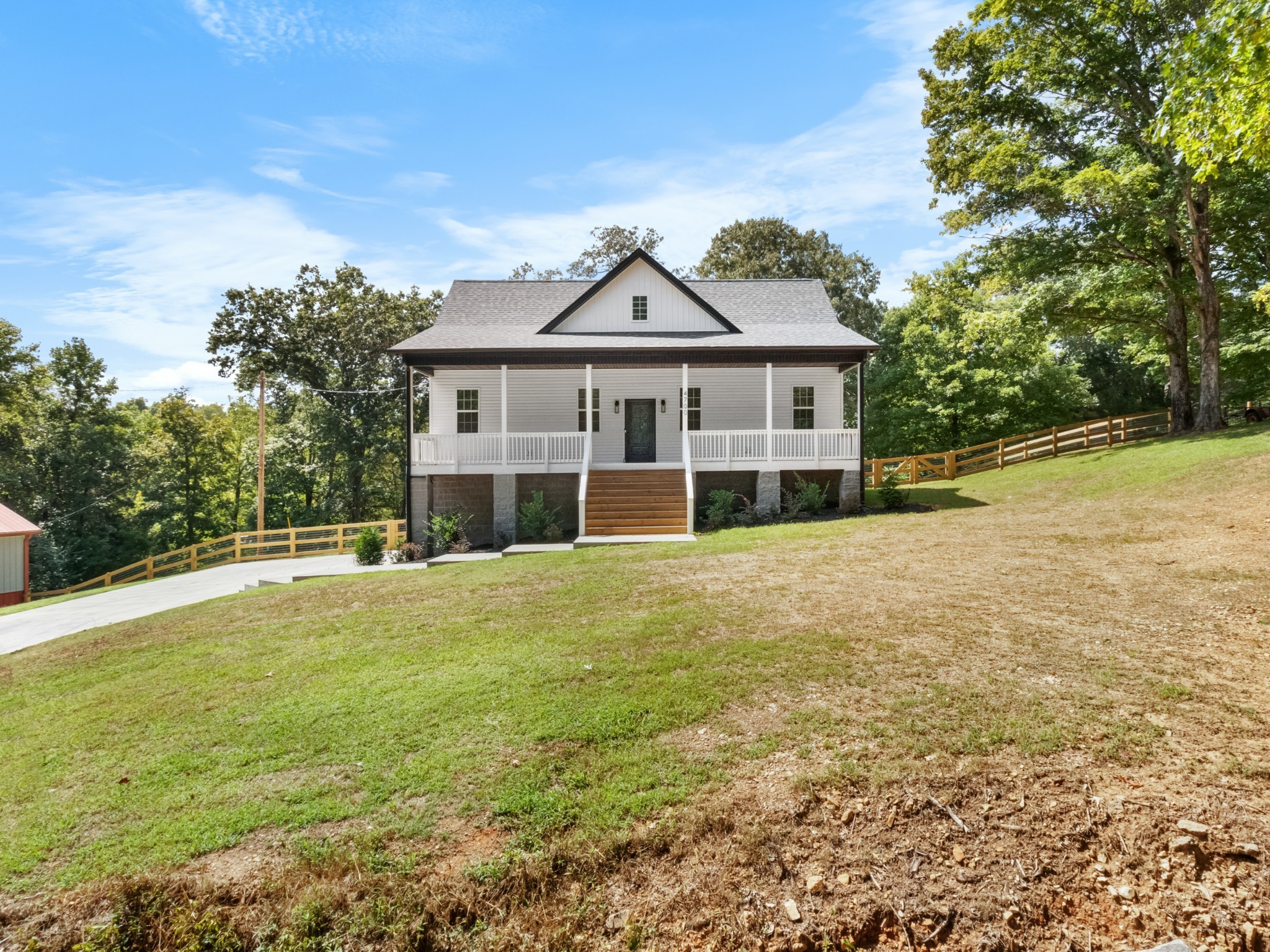 4700 Akin Road Cunningham, TN 37052 - Photo 2 of 36 a front view of a house with a garden