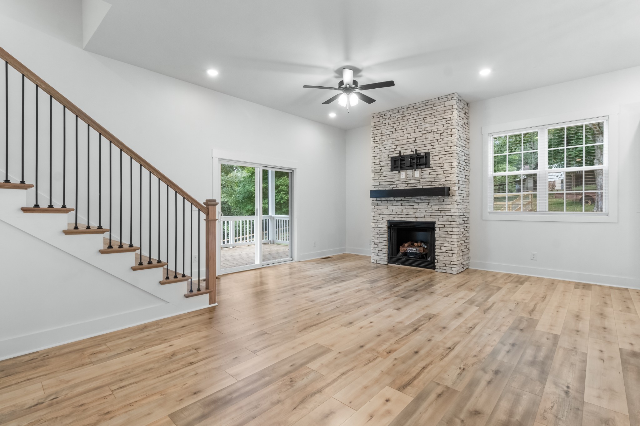 4700 Akin Road Cunningham, TN 37052 - Photo 8 of 36 a view of an empty room with wooden floor fireplace and a window