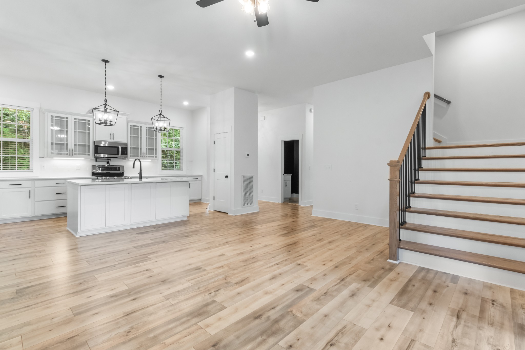 4700 Akin Road Cunningham, TN 37052 - Photo 9 of 36 a view of a kitchen with wooden floor and stainless steel appliances