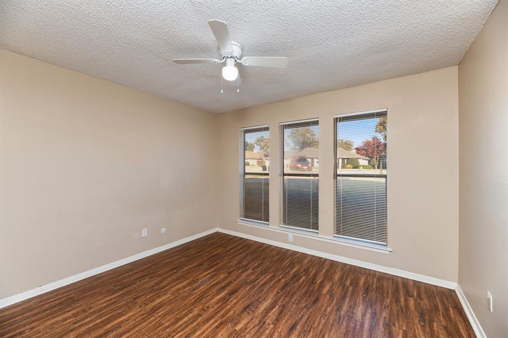 2317 Jenson Circle Fort Worth, TX 76112 - Photo 12 of 21 wooden floor in an empty room with a window