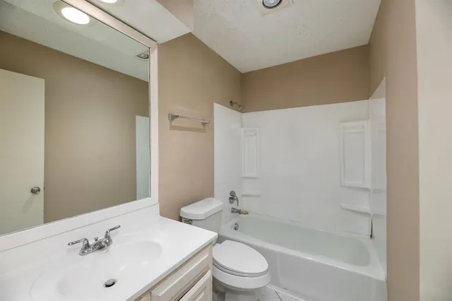 a bathroom with a sink mirror toilet and bathtub