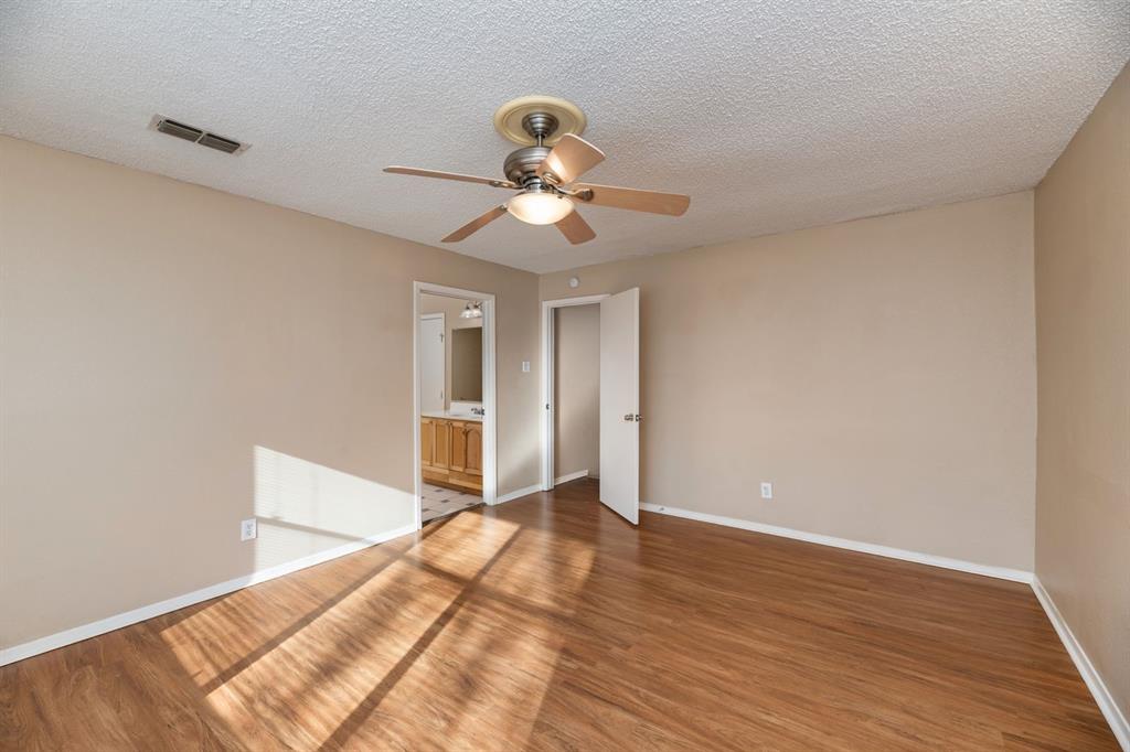 2317 Jenson Circle Fort Worth, TX 76112 - Photo 17 of 21 a view of a room with wooden floor and a ceiling fan