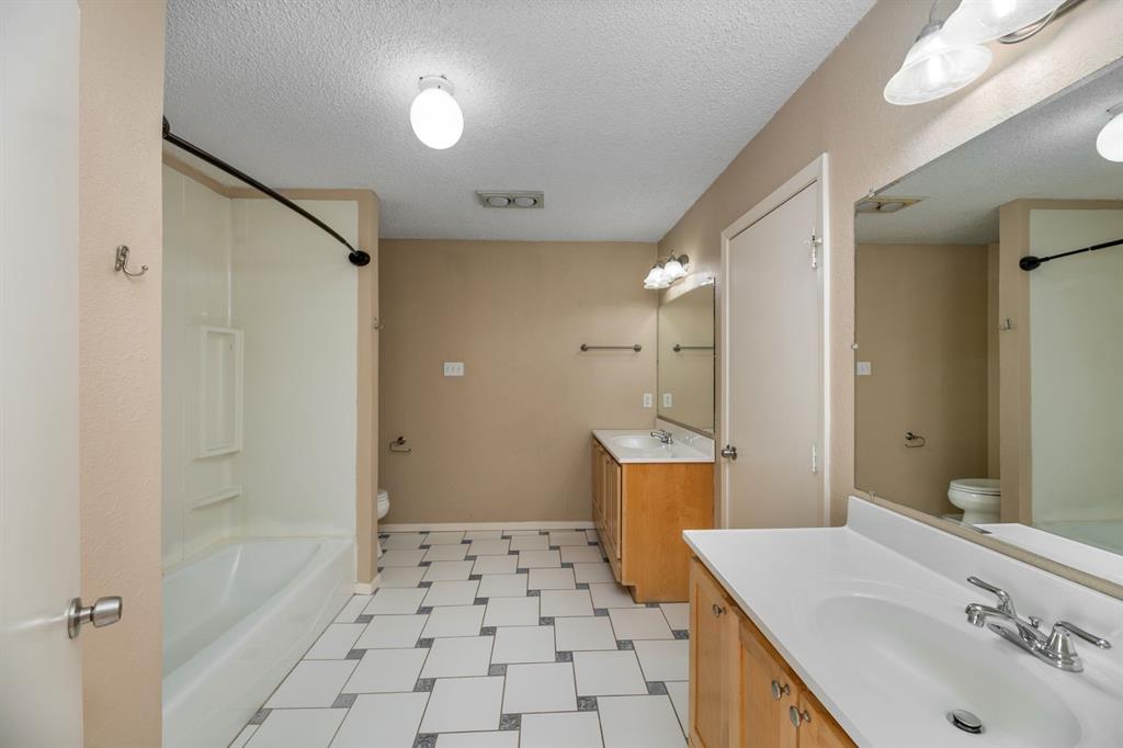 2317 Jenson Circle Fort Worth, TX 76112 - Photo 18 of 21 a bathroom with a sink a toilet and shower
