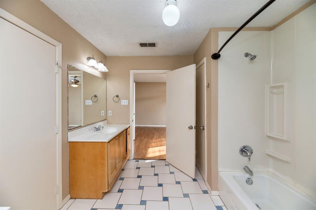 2317 Jenson Circle Fort Worth, TX 76112 - Photo 19 of 21 a bathroom with a sink a toilet and shower