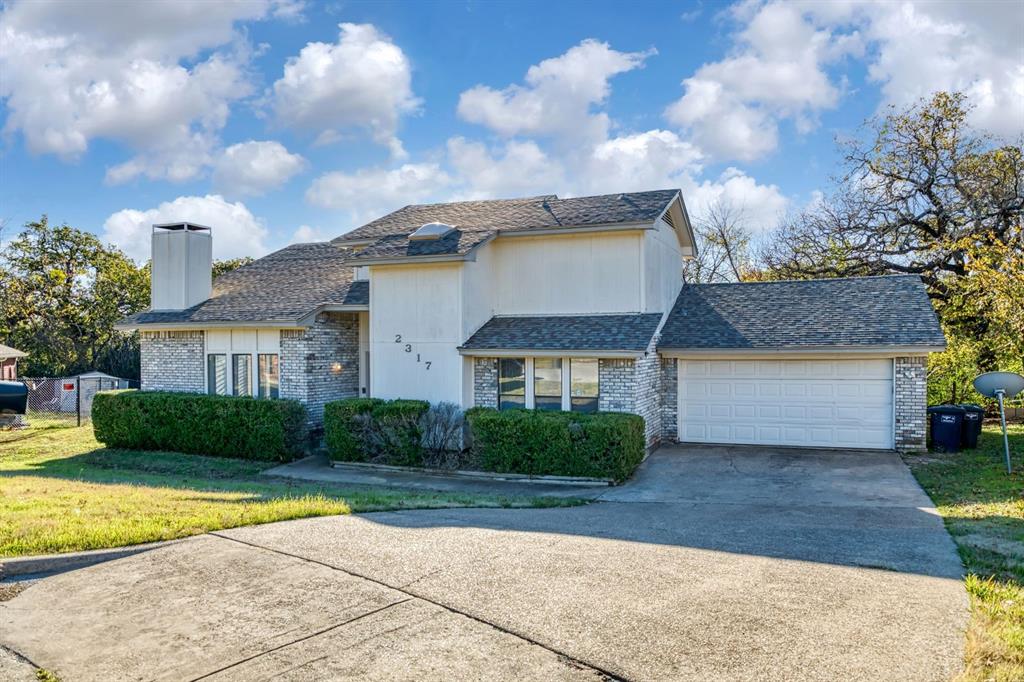 2317 Jenson Circle Fort Worth, TX 76112 - Photo 2 of 21 a front view of a house with garden