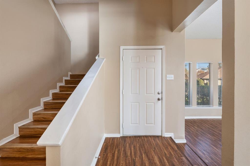 2317 Jenson Circle Fort Worth, TX 76112 - Photo 4 of 21 a view of a hallway with wooden floor and entryway