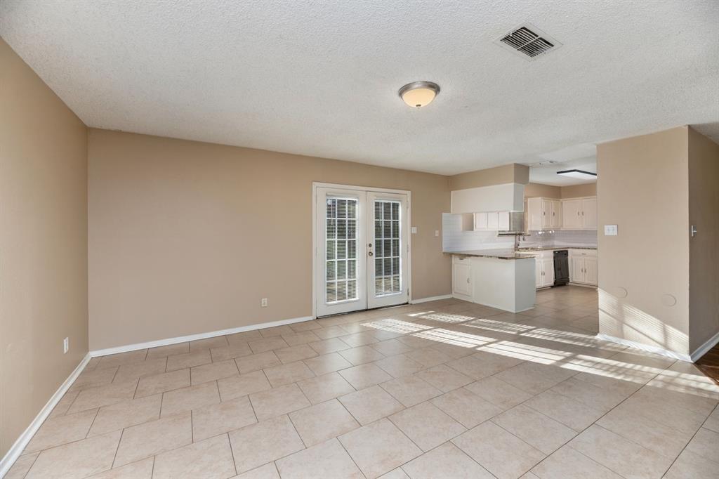 2317 Jenson Circle Fort Worth, TX 76112 - Photo 7 of 21 a view of a kitchen with a sink cabinets and a window