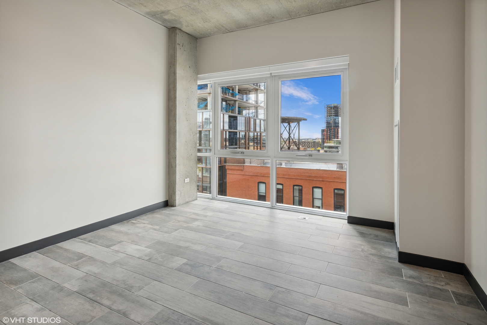171 North Aberdeen Street, Unit 903 Chicago, IL 60607 - Photo 6 of 15 a view of a room with wooden floor and a window