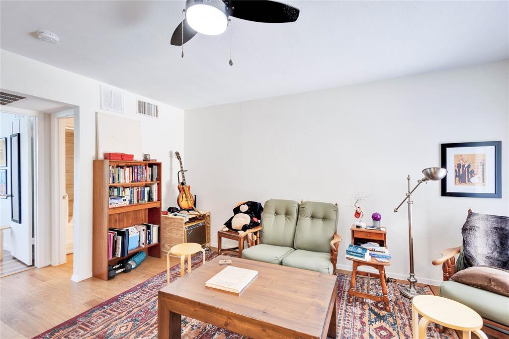 2207 Leon Street, Unit 303 Austin, TX 78705 - Photo 2 of 12 a living room with furniture and a bookshelf