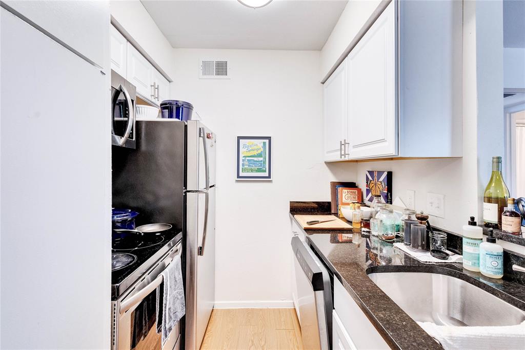2207 Leon Street, Unit 303 Austin, TX 78705 - Photo 6 of 12 a kitchen with stainless steel appliances granite countertop a sink stove and refrigerator