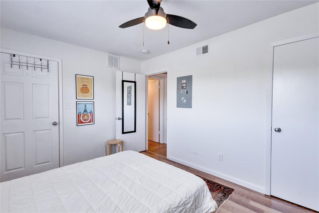 2207 Leon Street, Unit 303 Austin, TX 78705 - Photo 8 of 12 a bedroom with a bed and a chandelier