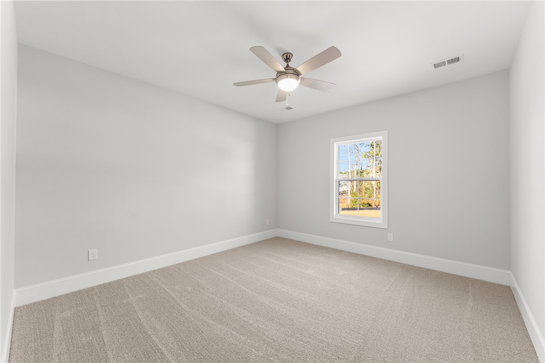 141 Rickys Path Easley, SC 29642 - Photo 29 of 40 This spacious bedroom offers ample light and comfort for peaceful living.