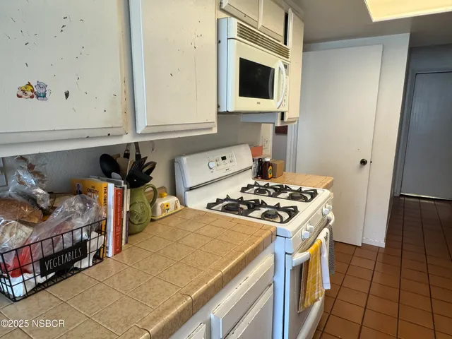 a kitchen with stainless steel appliances a stove a microwave and a refrigerator