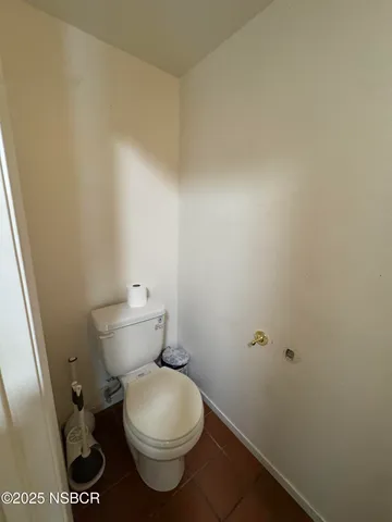 a white toilet sitting next to a shower