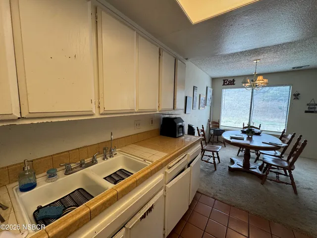 a kitchen with a table and chairs