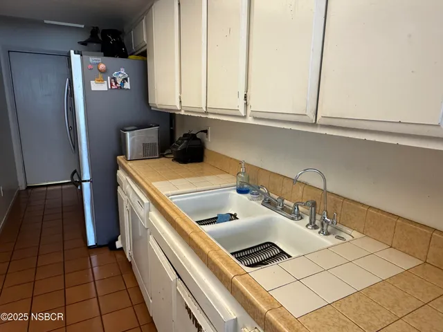 a kitchen with a sink and a refrigerator