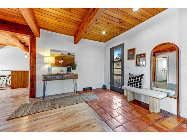 a view of a livingroom with wooden floor and furniture