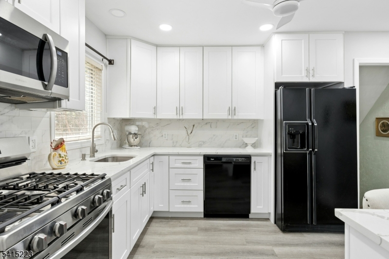 33 Carol Road Westfield, NJ 07090 - Photo 10 of 23 a kitchen with stainless steel appliances granite countertop a stove and a refrigerator