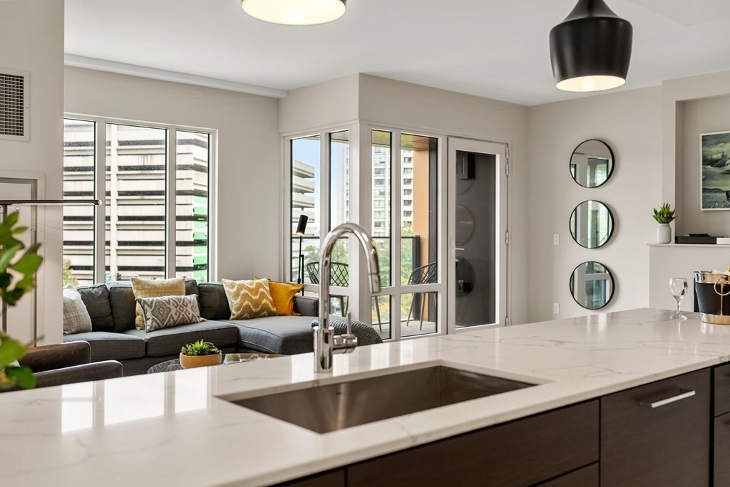 110 Broad Street, Unit 401 Boston, MA 02110 - Photo 11 of 24 a living room with furniture and window