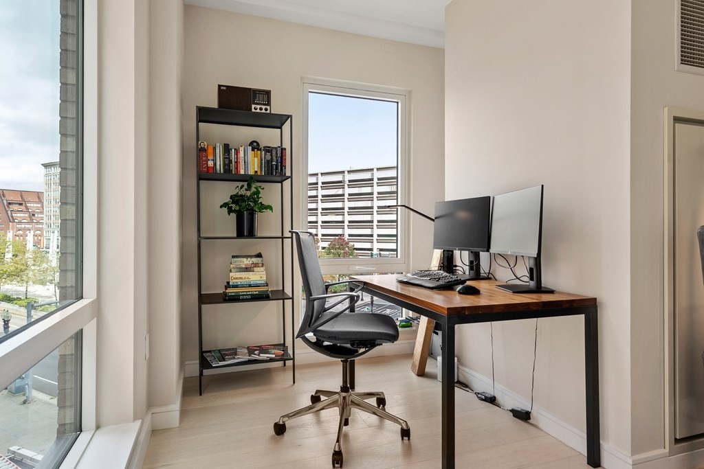 110 Broad Street, Unit 401 Boston, MA 02110 - Photo 13 of 24 a view of a workspace with furniture and a window